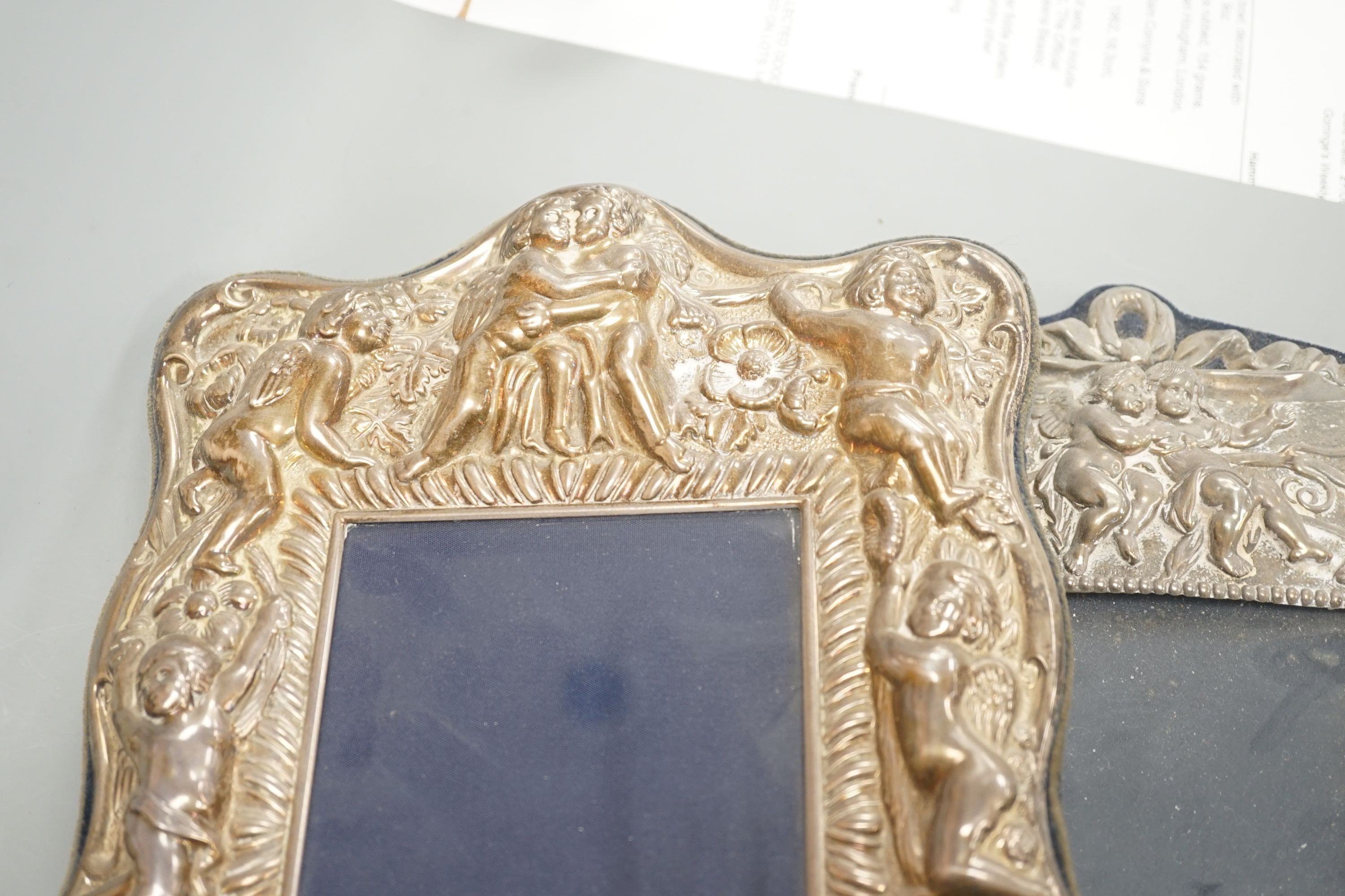 Three assorted ornate modern silver mounted photograph frames, largest overall 33.5cm.